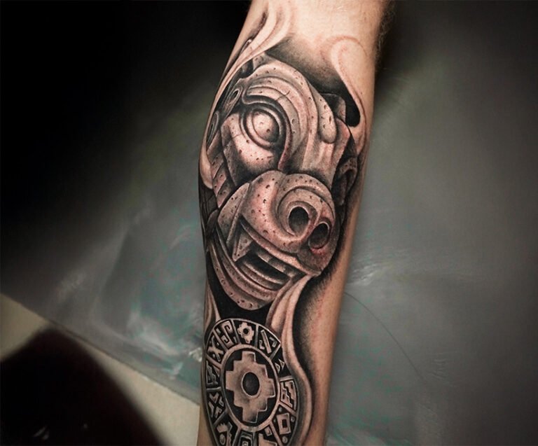 Black and grey realism tattoo of a stone puma with an Inca calendar featuring a Chakana in the center, created at NOIR Tattoo Studio in Cusco, Peru.