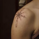 Fine line tattoo of a sacred star with Andean-inspired geometric patterns, created at NOIR Tattoo Studio in Cusco, Peru.