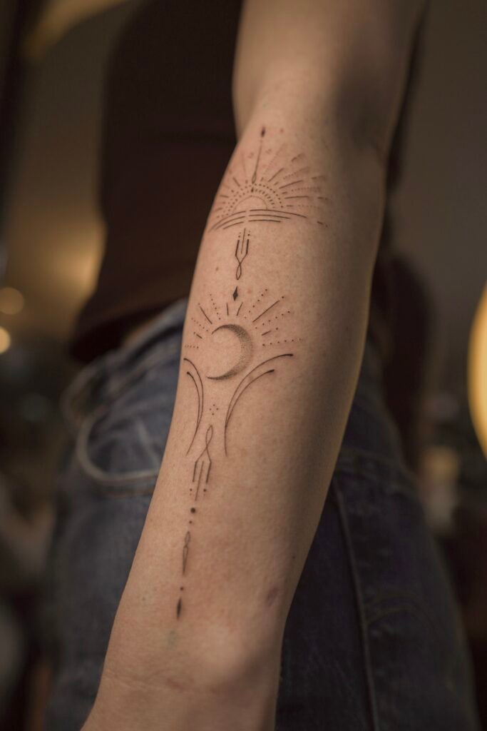 Delicate fineline tattoo featuring sun and moon symbols connected by sacred geometric lines, representing balance, renewal, and spiritual harmony. Created at NOIR Tattoo Cusco, Peru.