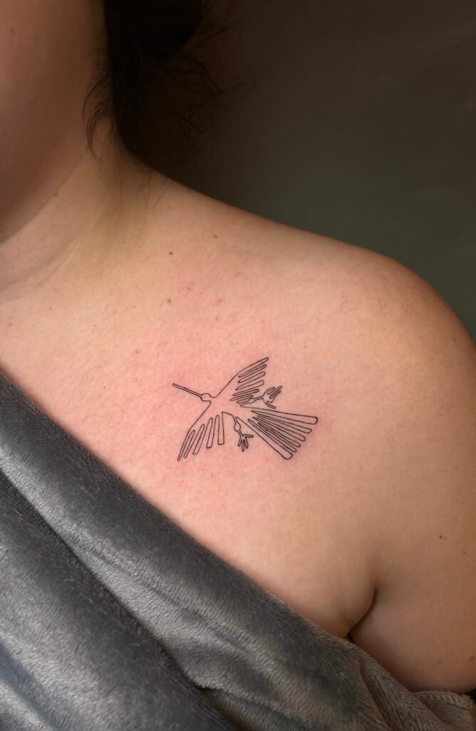 Fine line tattoo of the Nazca hummingbird geoglyph, an ancient Andean symbol representing energy, movement, and spiritual connection, created at NOIR Tattoo Studio in Cusco, Peru.
