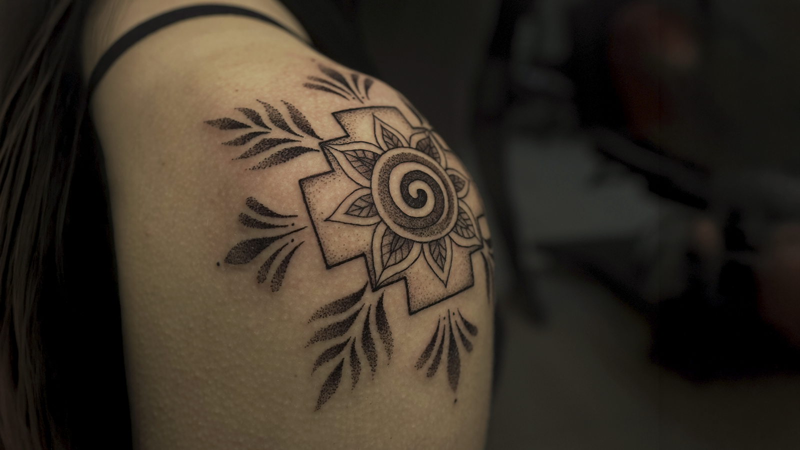 Andean Chakana tattoo with sacred geometry, spiral sun, and ornamental blackwork, tattooed at Noir Tattoo Cusco, Peru.