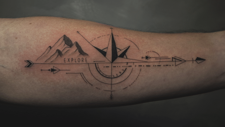 Geometric compass and mountain tattoo on the forearm with the word "Explore," symbolizing adventure, travel, and direction.