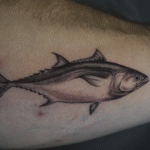 Realistic bluefin tuna tattoo in black and grey, featuring detailed marine life illustration, tattooed at Noir Tattoo Cusco, Peru.