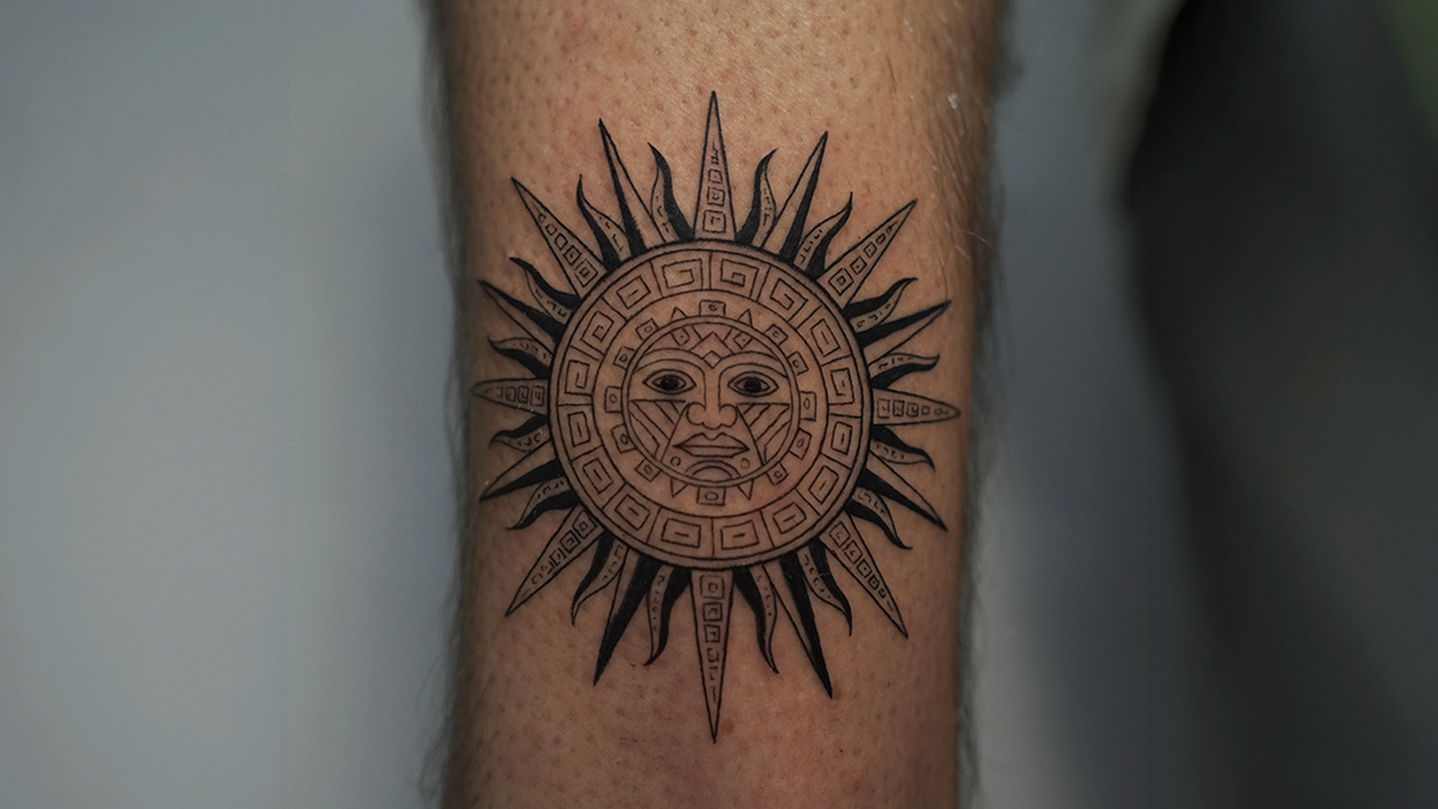 Blackwork tattoo of Inti, the Inca Sun God, inspired by Andean symbolism and ancient Peruvian culture, tattooed at Noir Tattoo Cusco, Peru.