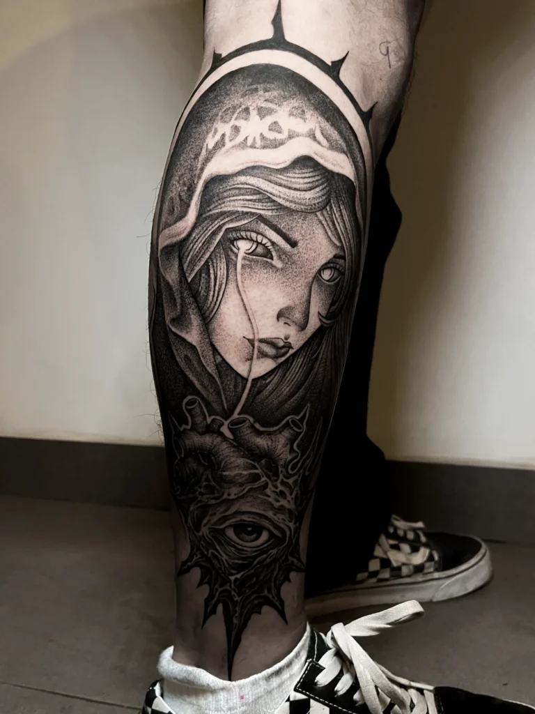 Dark surreal blackwork tattoo on the leg at Noir Tattoo Cusco