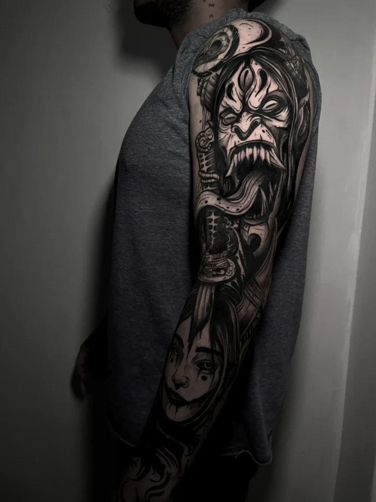 Dark fantasy blackwork sleeve tattoo on the arm at Noir Tattoo Cusco